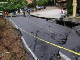 road destroyed by a huge sinkhole